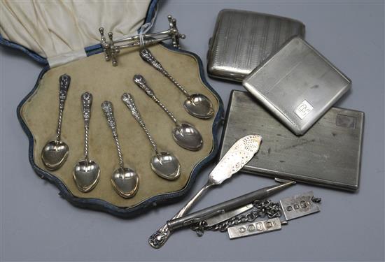 Three silver cigarette cases, a cased set of six silver teaspoons, a pair of silver knife rests and five other silver items.